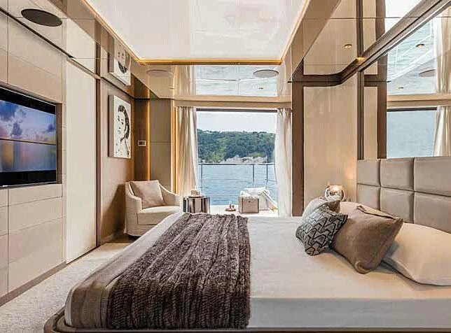 a large bed in a room aboard RINO Yacht for Sale