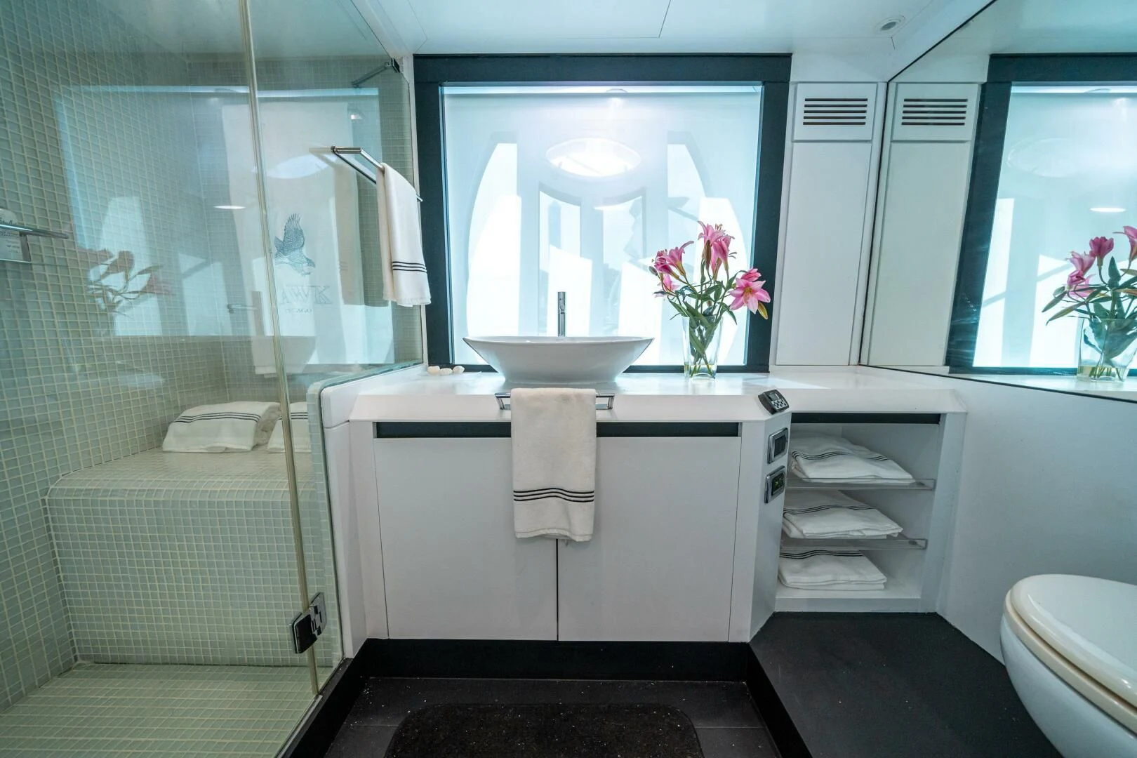 a bathroom with a sink and a mirror aboard HAWK Yacht for Charter