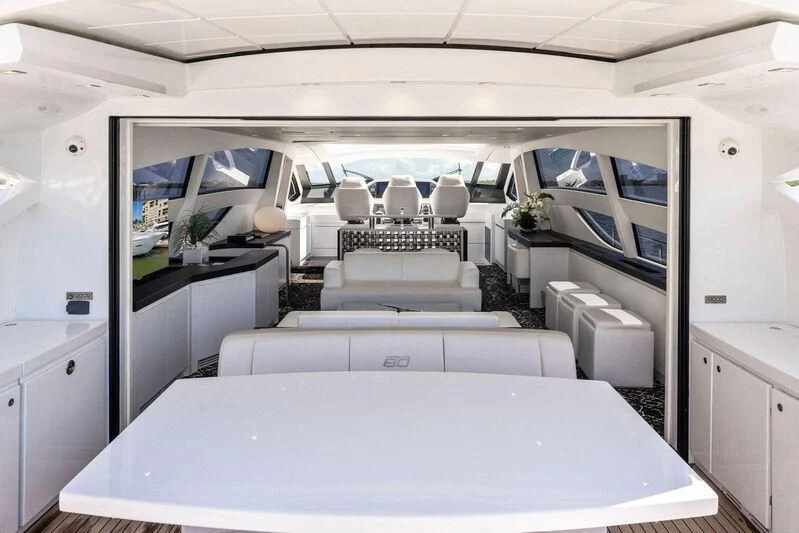 a room with a table chairs and a large window aboard HAWK Yacht for Charter