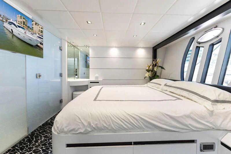 a white bed in a room aboard HAWK Yacht for Charter