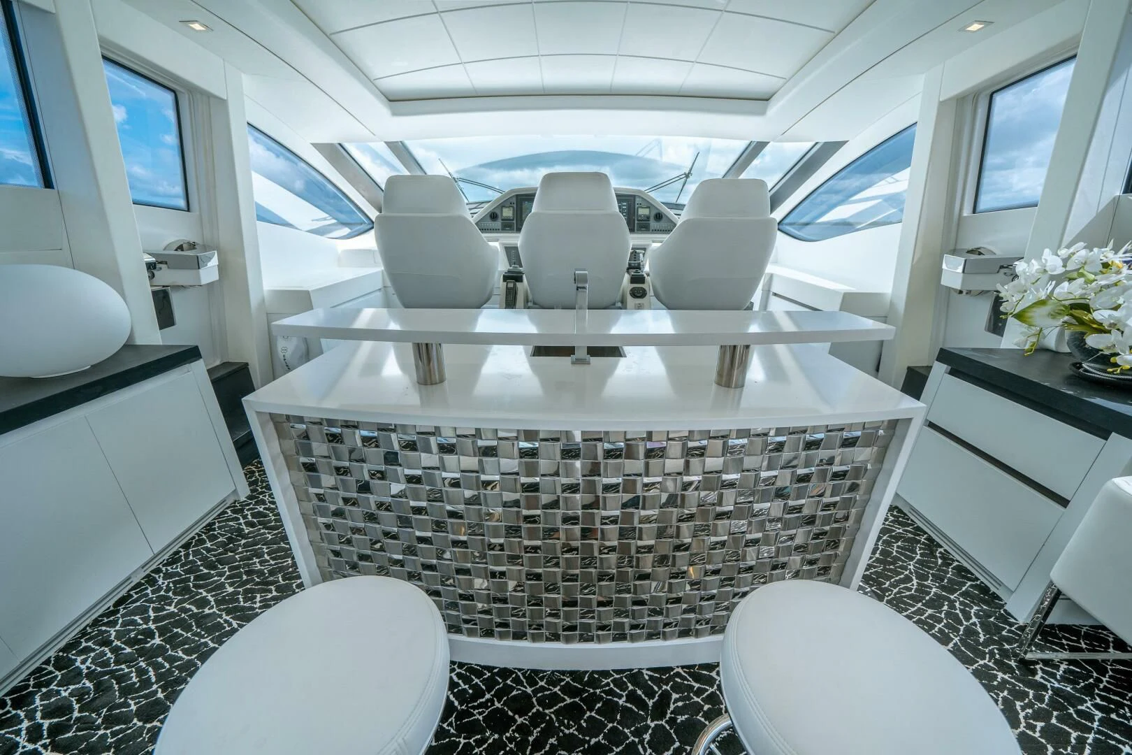 a white room with a table and chairs aboard HAWK Yacht for Charter