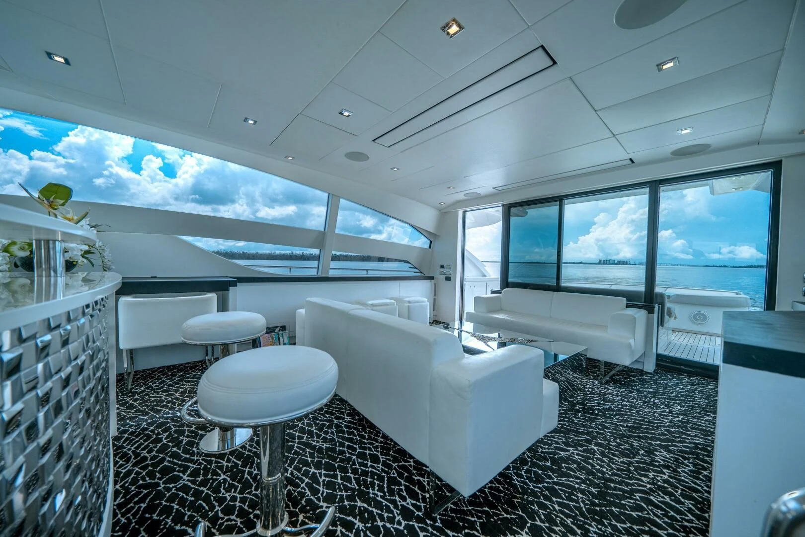a room with a white couch and a white chair aboard HAWK Yacht for Charter