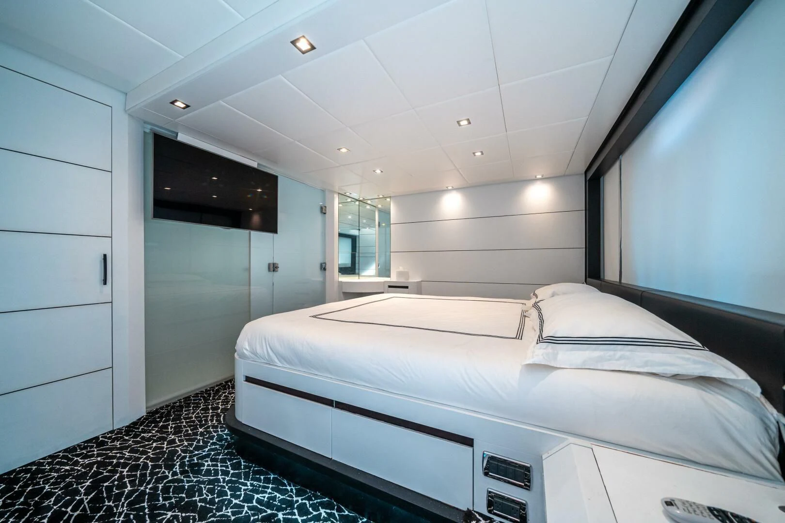 a room with a bed and a desk aboard HAWK Yacht for Charter