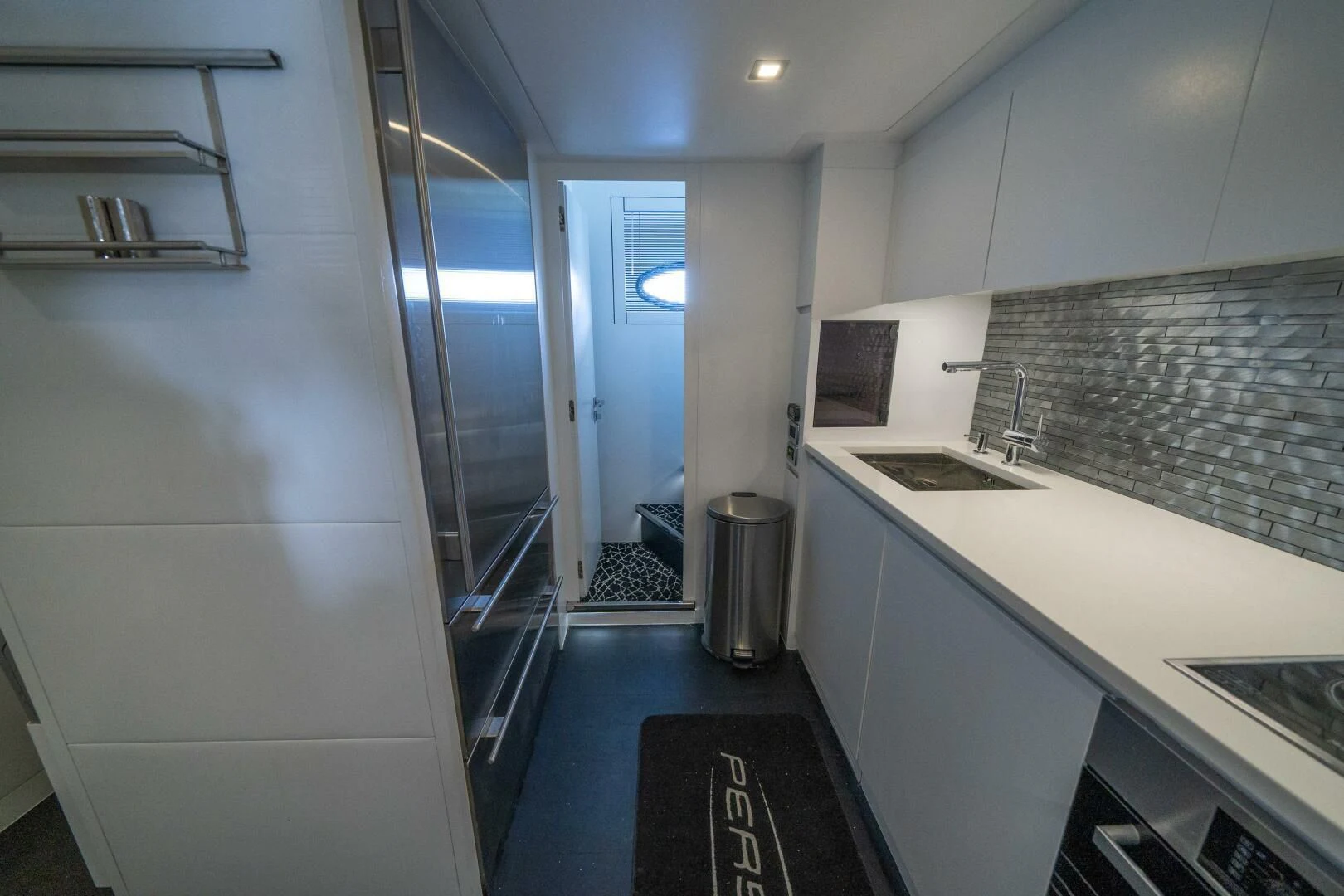 a kitchen with white cabinets aboard HAWK Yacht for Charter