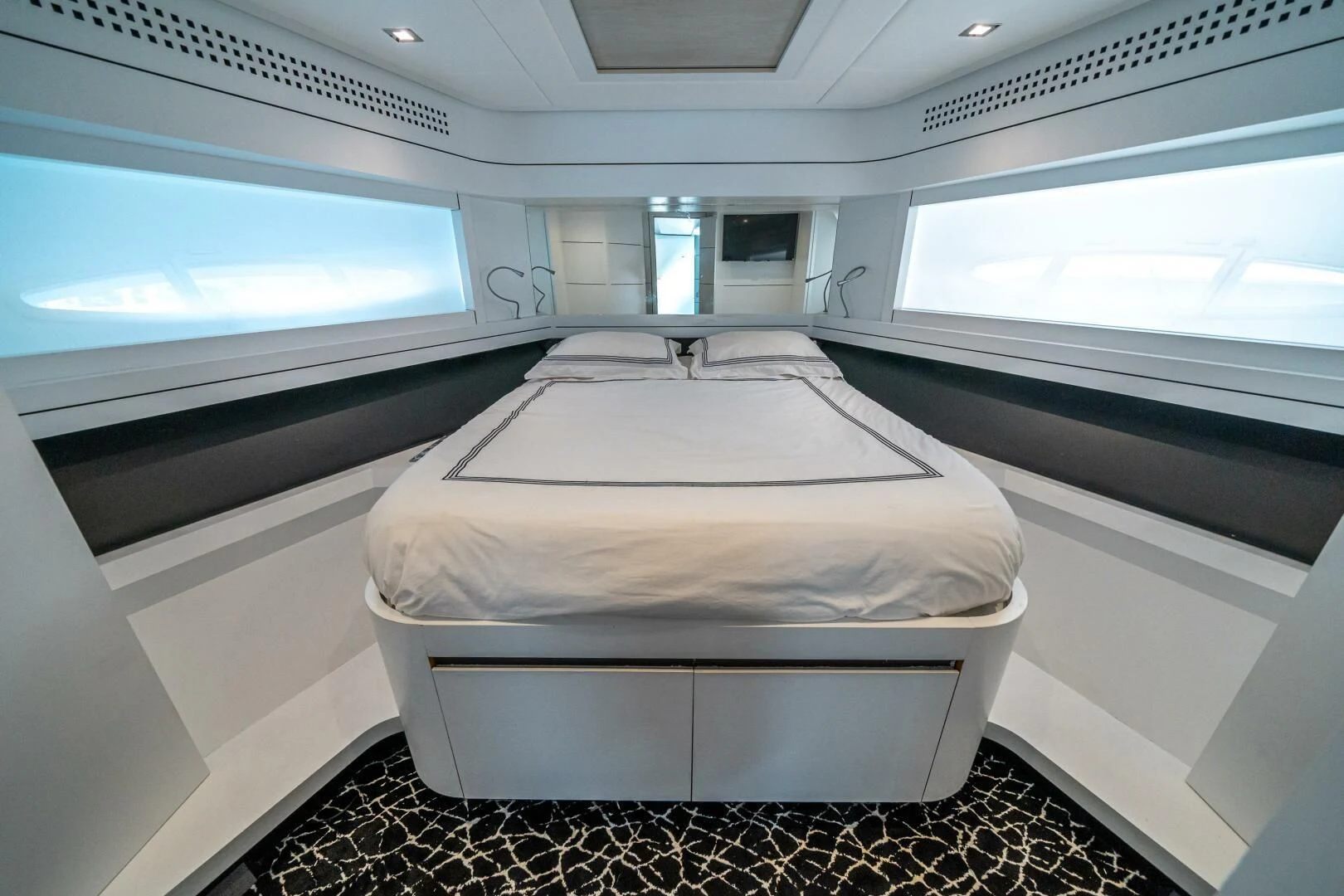 a room with a bed and a window aboard HAWK Yacht for Charter
