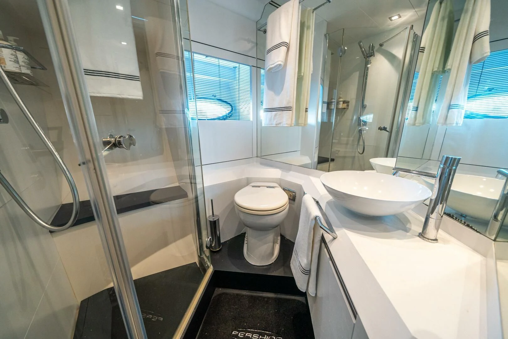 a bathroom with a glass shower aboard HAWK Yacht for Charter