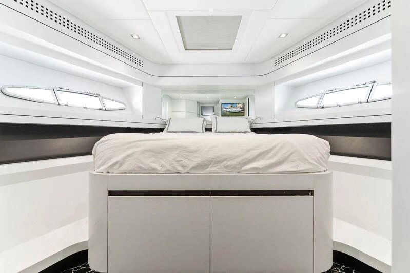 a room with a bed and a window aboard HAWK Yacht for Charter