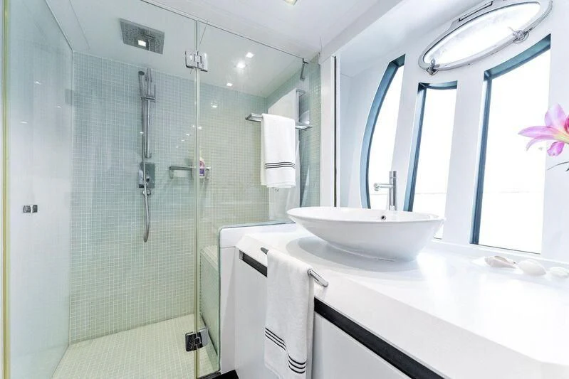 a bathroom with a glass shower aboard HAWK Yacht for Charter