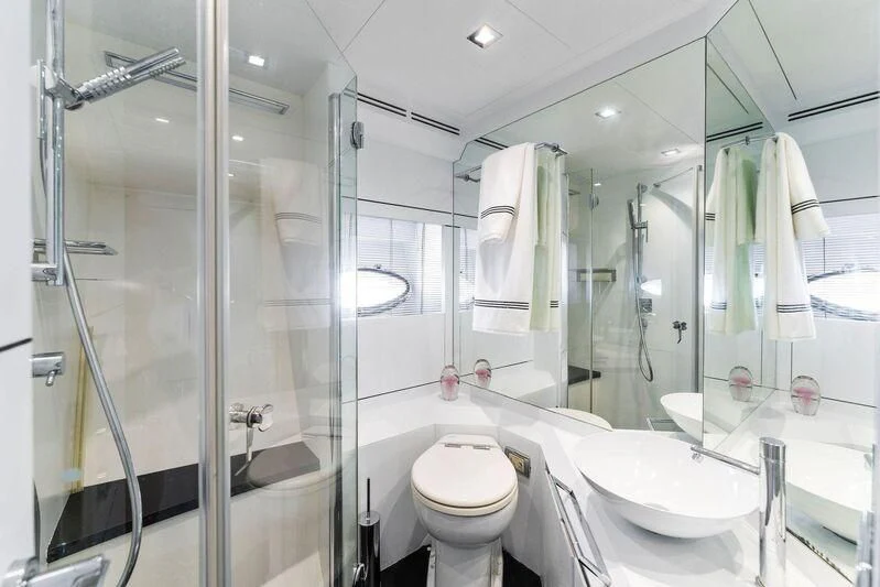 a bathroom with a glass shower aboard HAWK Yacht for Charter