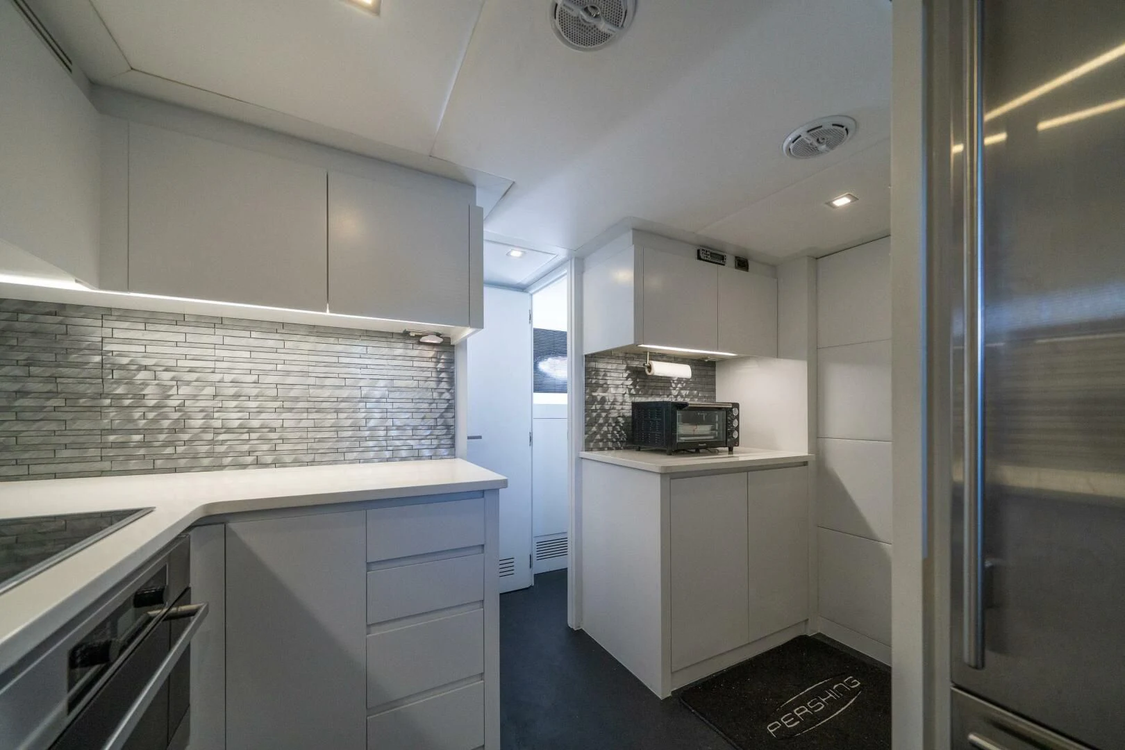 a kitchen with white cabinets aboard HAWK Yacht for Charter