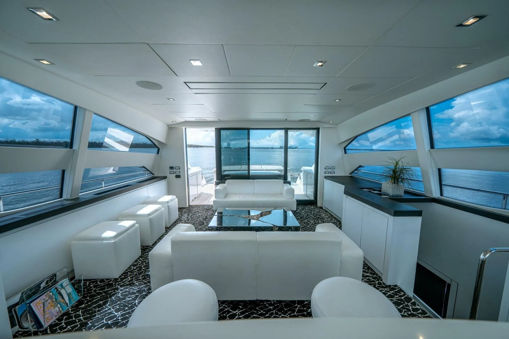 a room with a couch and a table and a window aboard HAWK Yacht for Charter