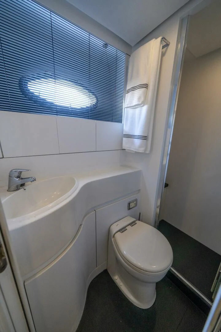 a bathroom with a toilet sink and a bathtub aboard HAWK Yacht for Charter