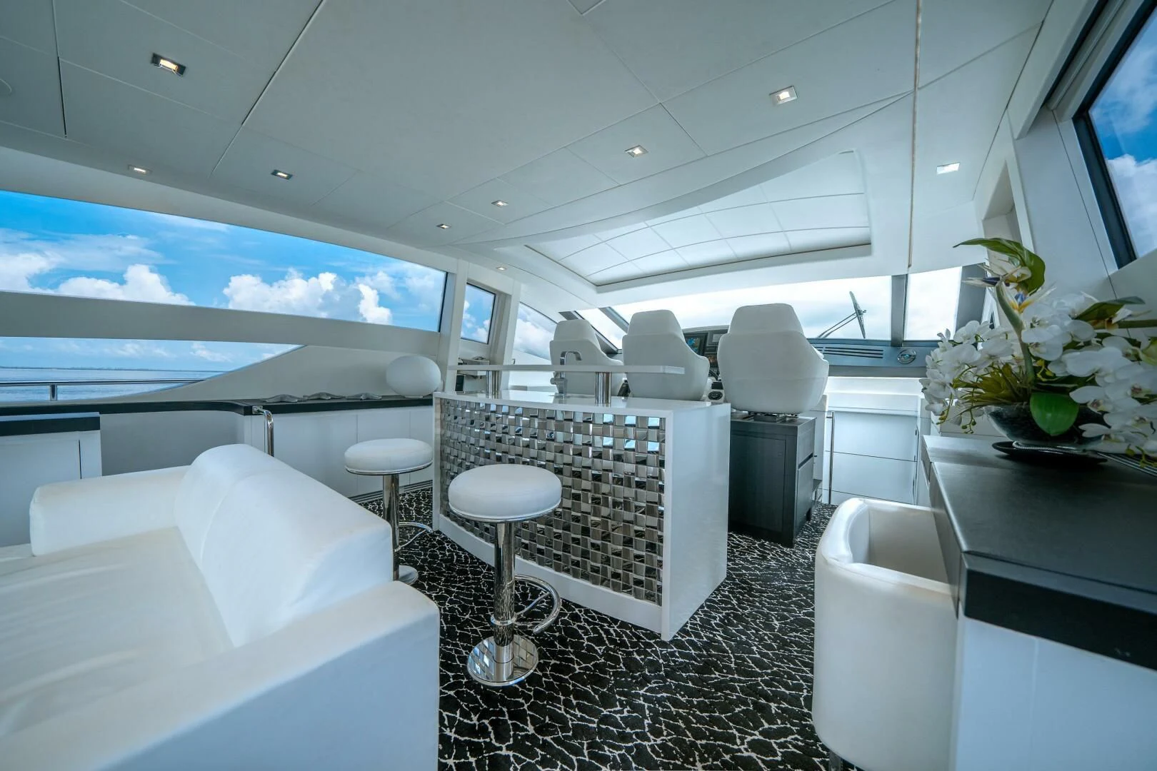 a room with a table chairs and a television aboard HAWK Yacht for Charter