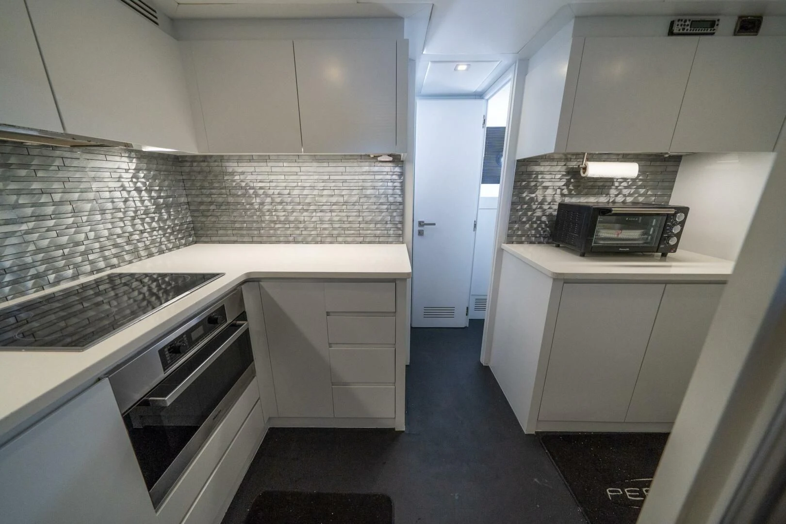 a kitchen with white cabinets aboard HAWK Yacht for Charter