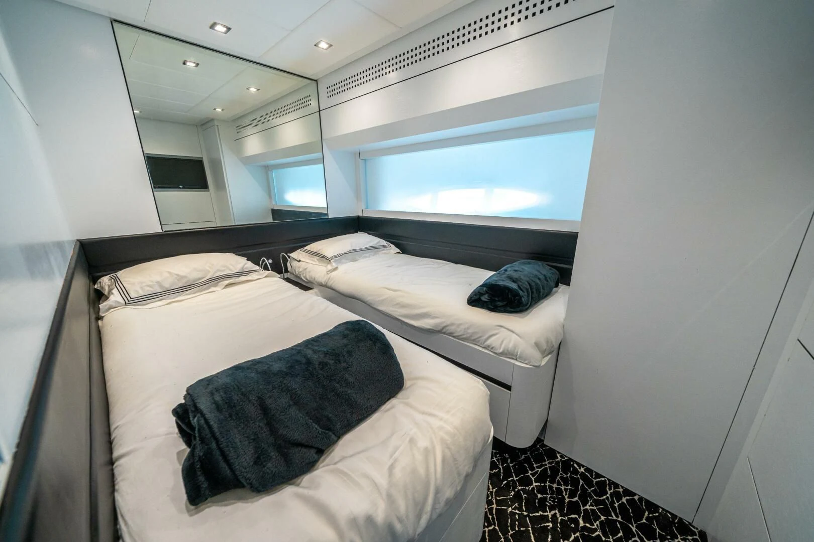 a room with a bed and a window aboard HAWK Yacht for Charter
