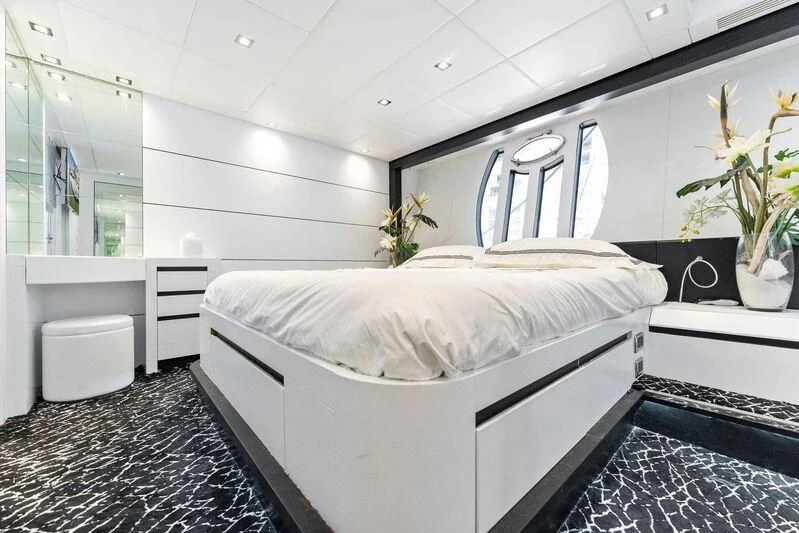 a white bed in a room aboard HAWK Yacht for Charter