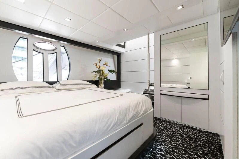 a room with a bed and a window aboard HAWK Yacht for Charter