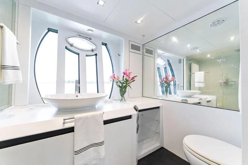 a bathroom with a large mirror aboard HAWK Yacht for Charter
