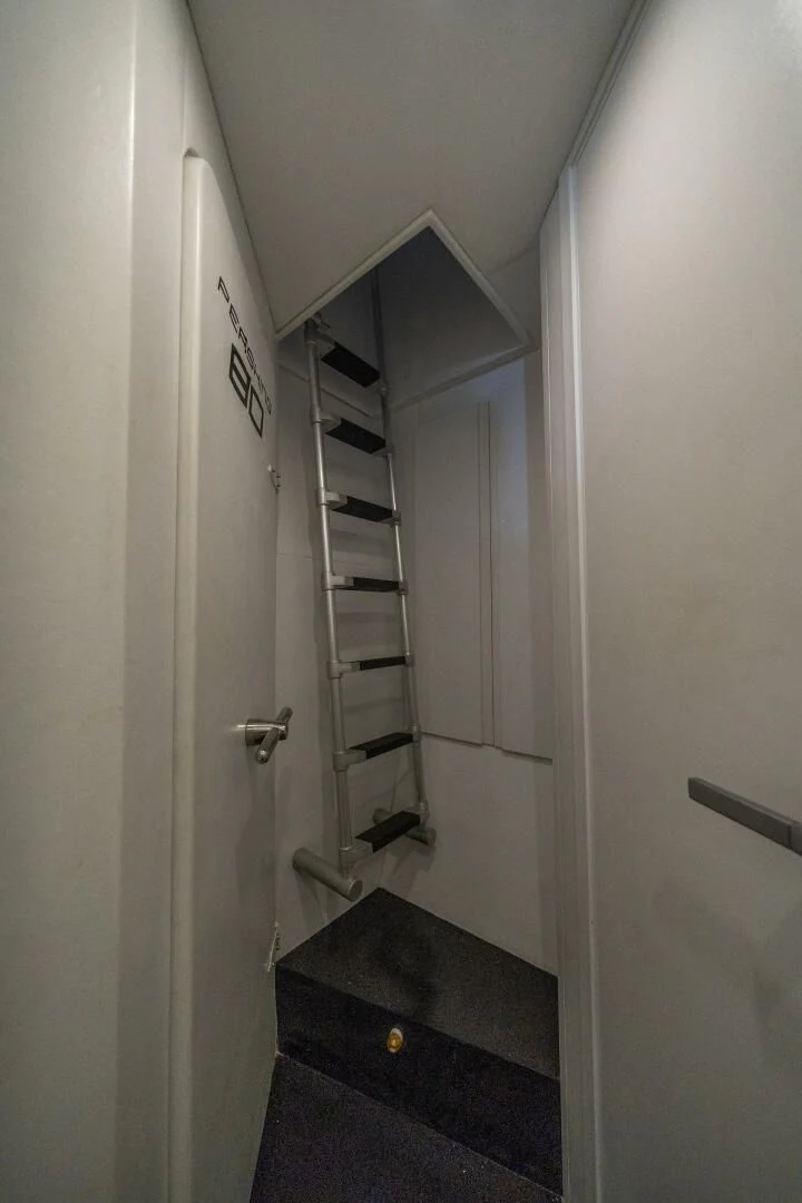 a white hallway with a black shelf aboard HAWK Yacht for Charter