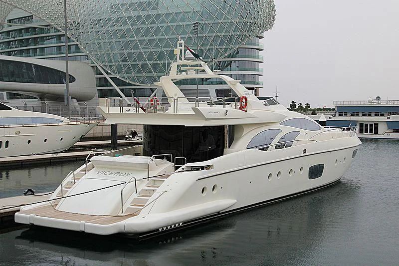 a white yacht in a harbor aboard SHELLS Yacht for Sale