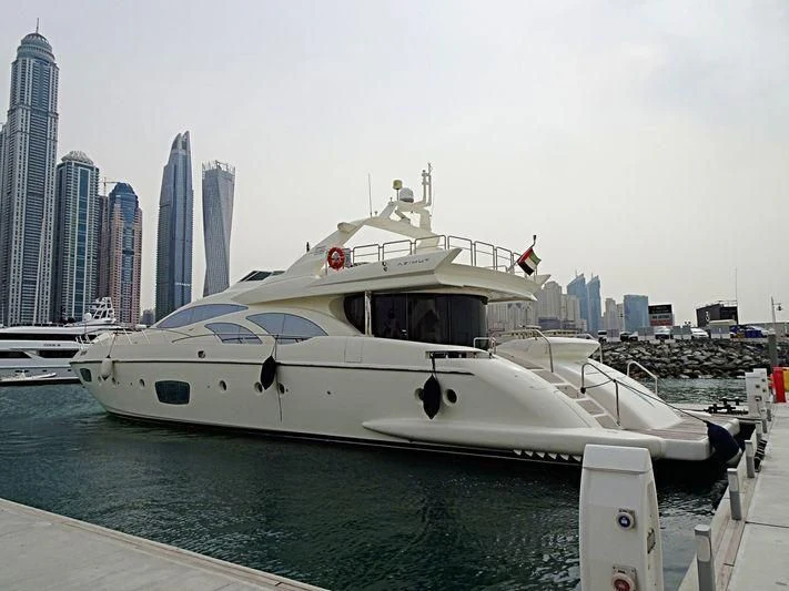 a white boat in a harbor aboard SHELLS Yacht for Sale