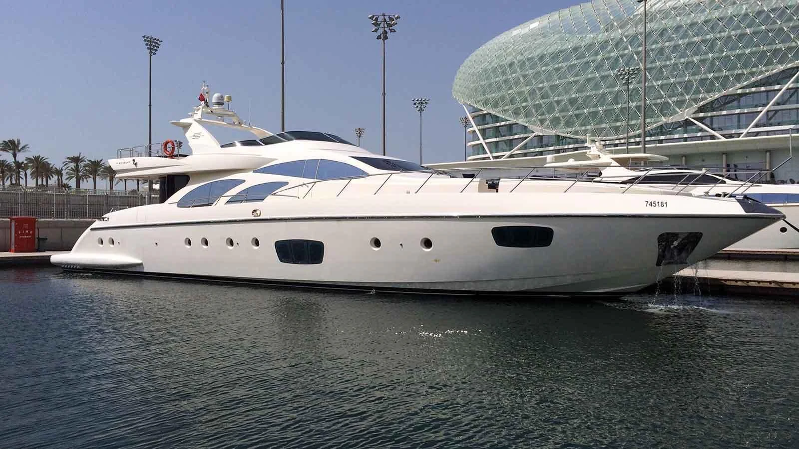 a white yacht in a harbor aboard SHELLS Yacht for Sale