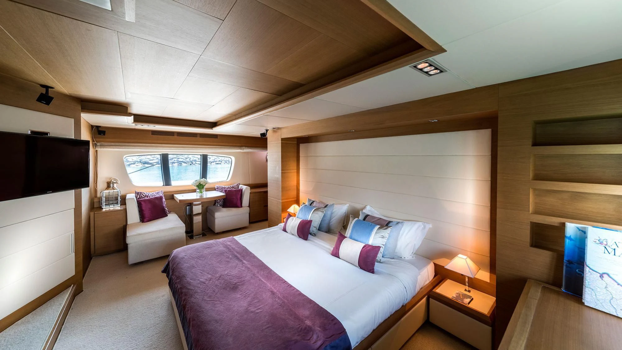a bedroom with a bed and a tv aboard SHELLS Yacht for Sale