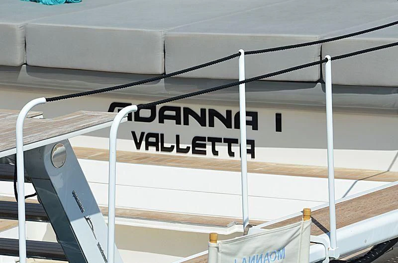 a white railing with black text on it aboard D&B Yacht for Sale