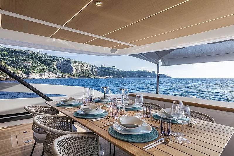 a table with plates and glasses on it aboard D&B Yacht for Sale