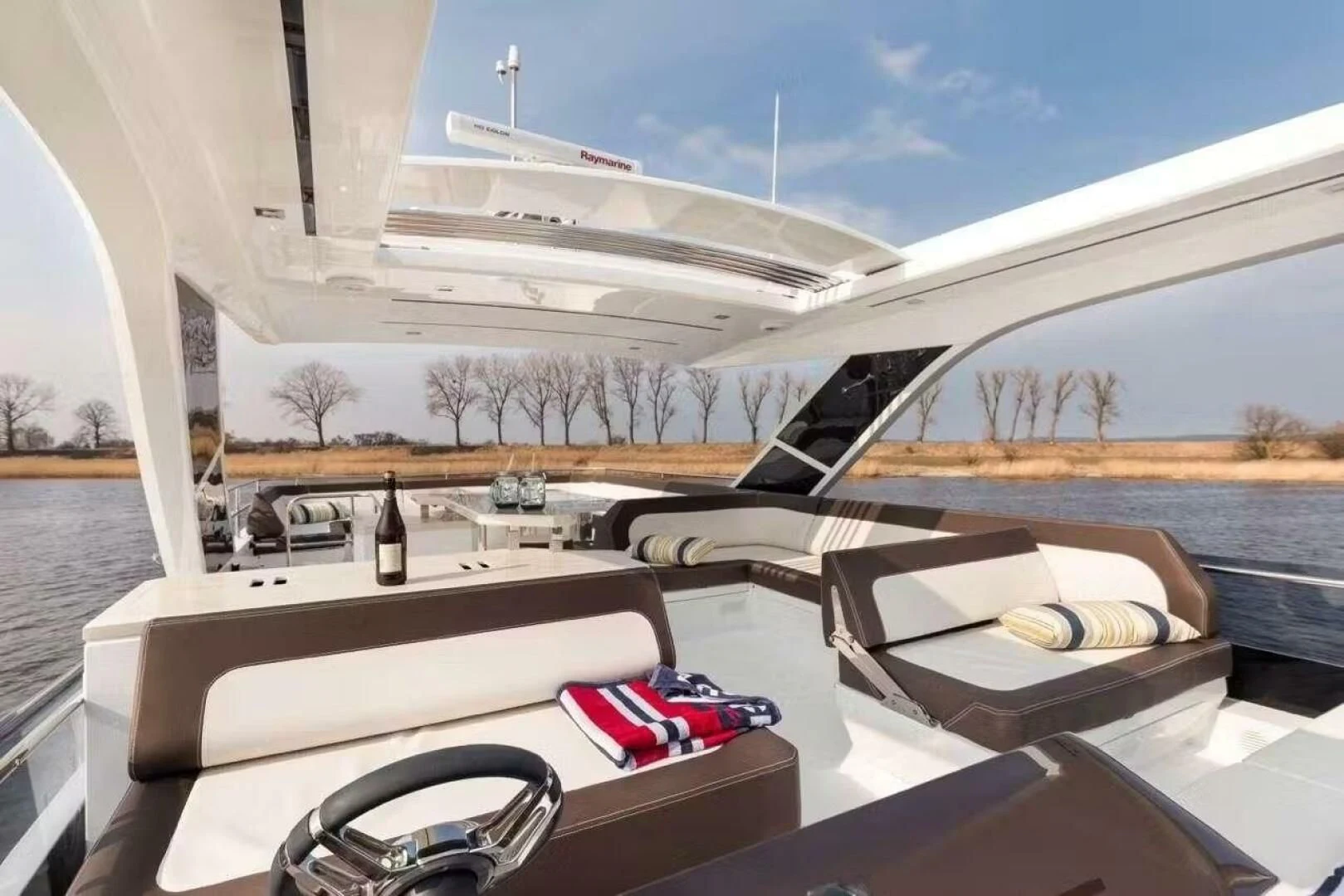 a room with a bed and a table and chairs aboard TRIPLE T Yacht for Sale