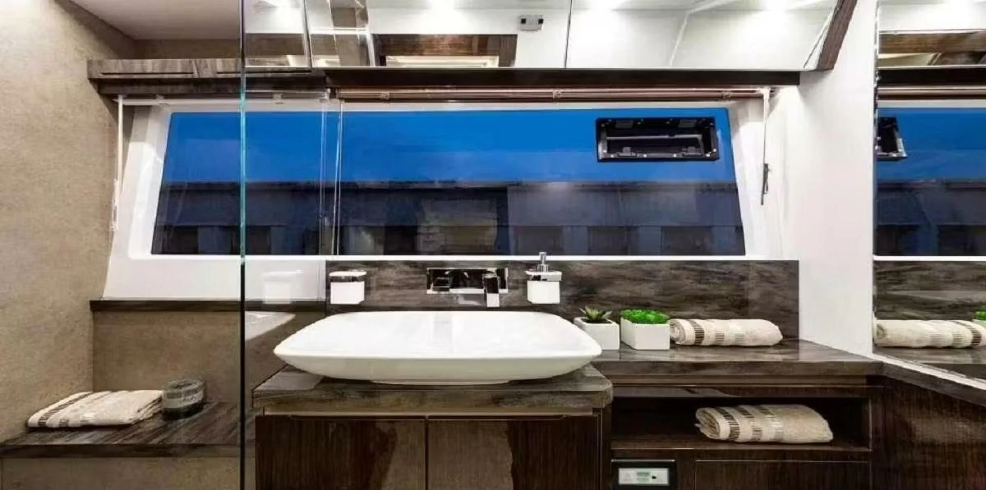 a bathroom with a large mirror aboard TRIPLE T Yacht for Sale