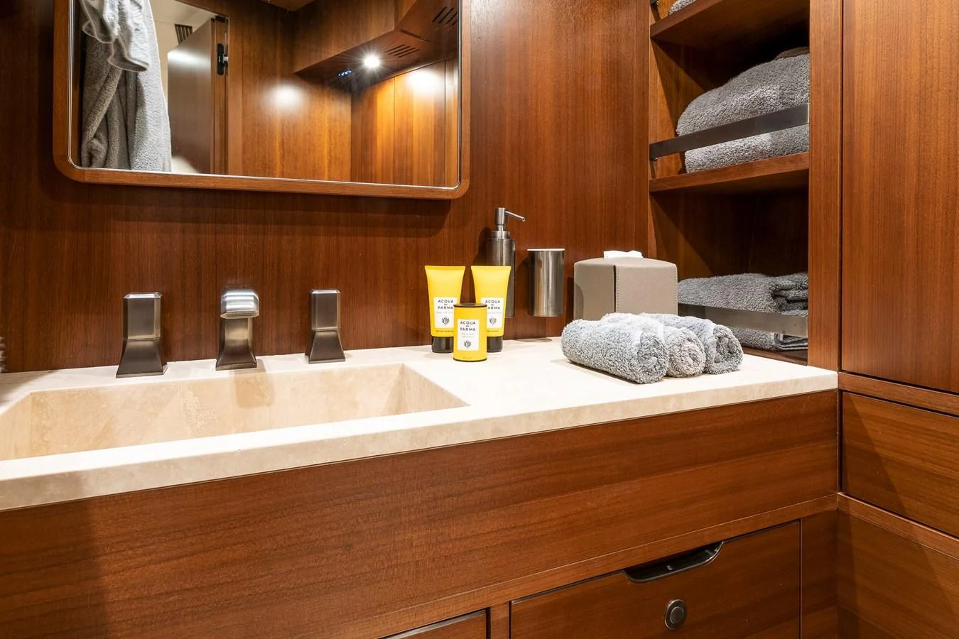 a bathroom with a countertop sink and wooden cabinets aboard ONE DAY Yacht for Sale