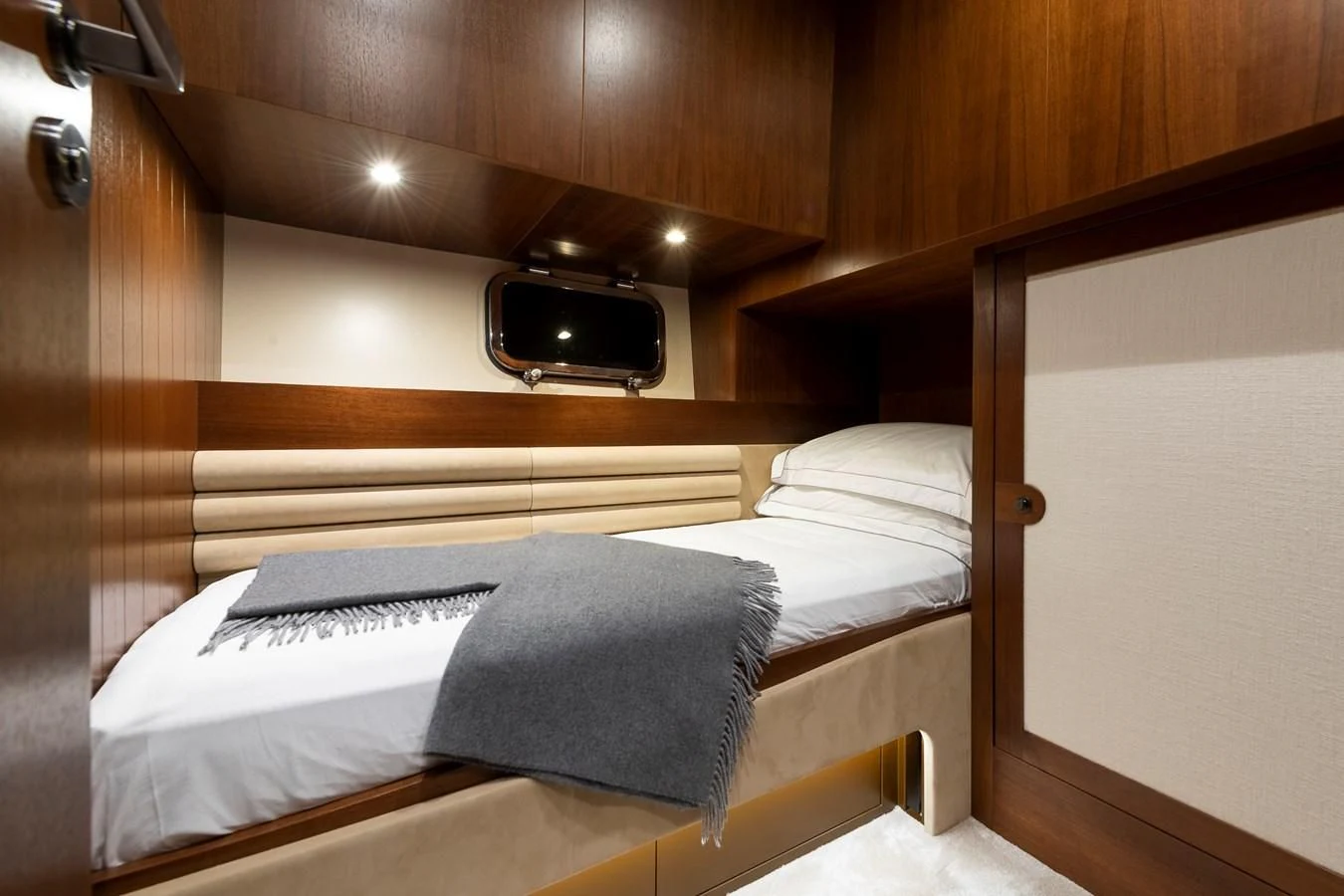 a bed with a television on the wall aboard ONE DAY Yacht for Sale