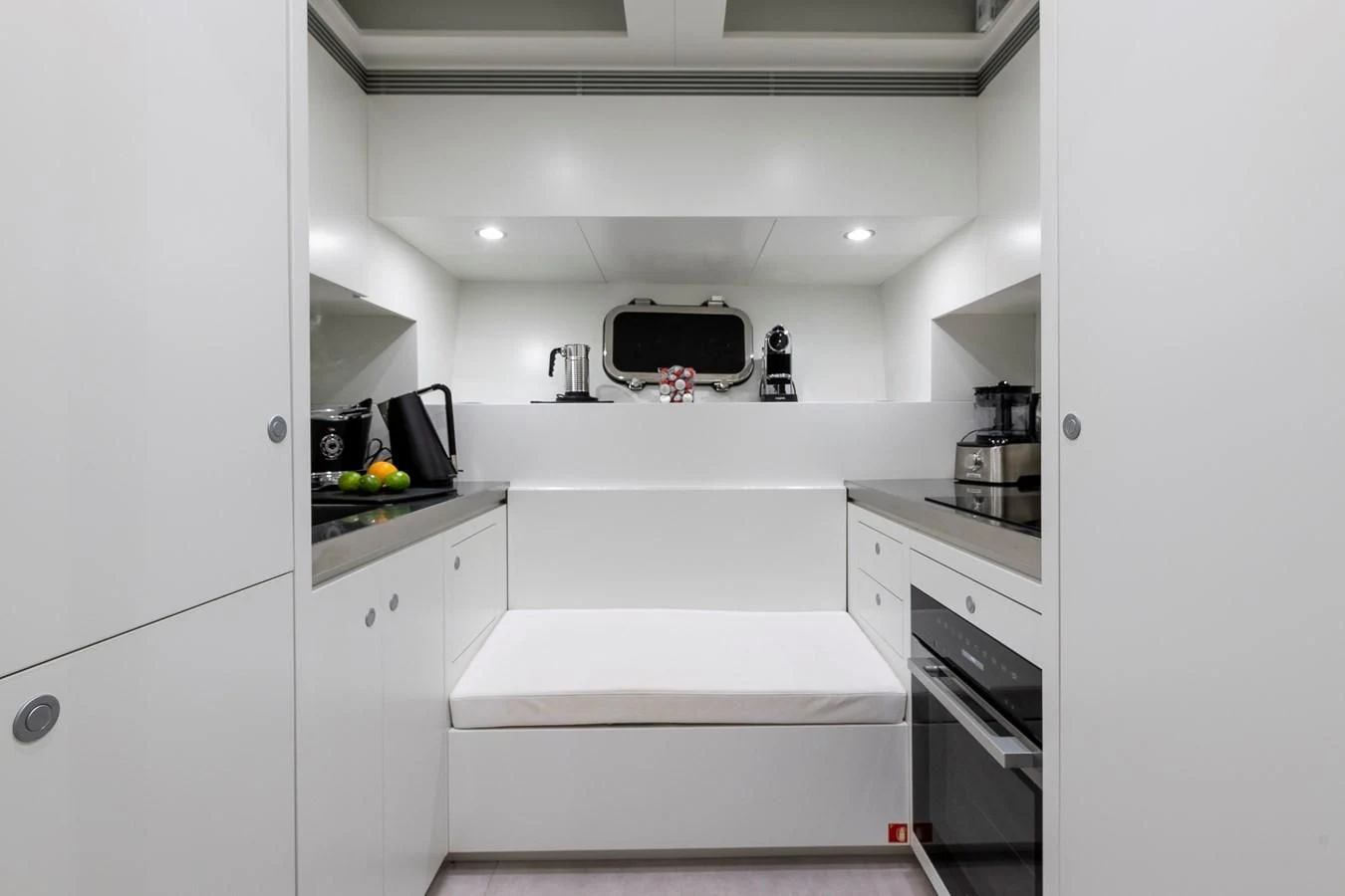 a kitchen with white cabinets aboard ONE DAY Yacht for Sale
