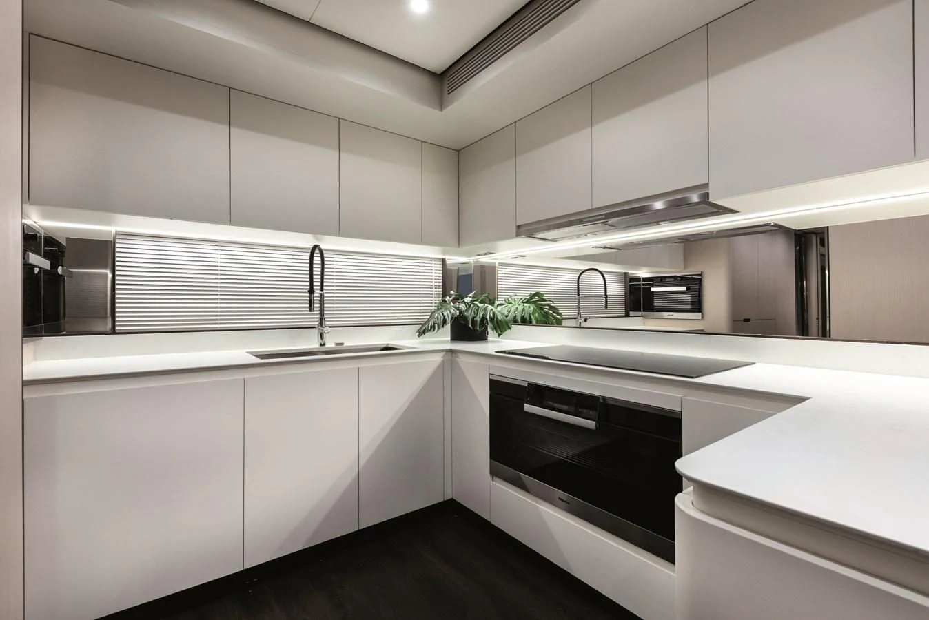 a kitchen with white cabinets aboard LA MAMA Yacht for Sale