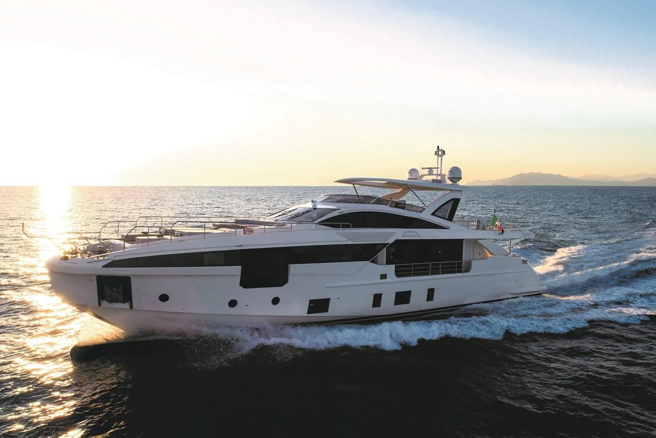 a white yacht on the water aboard LA MAMA Yacht for Sale