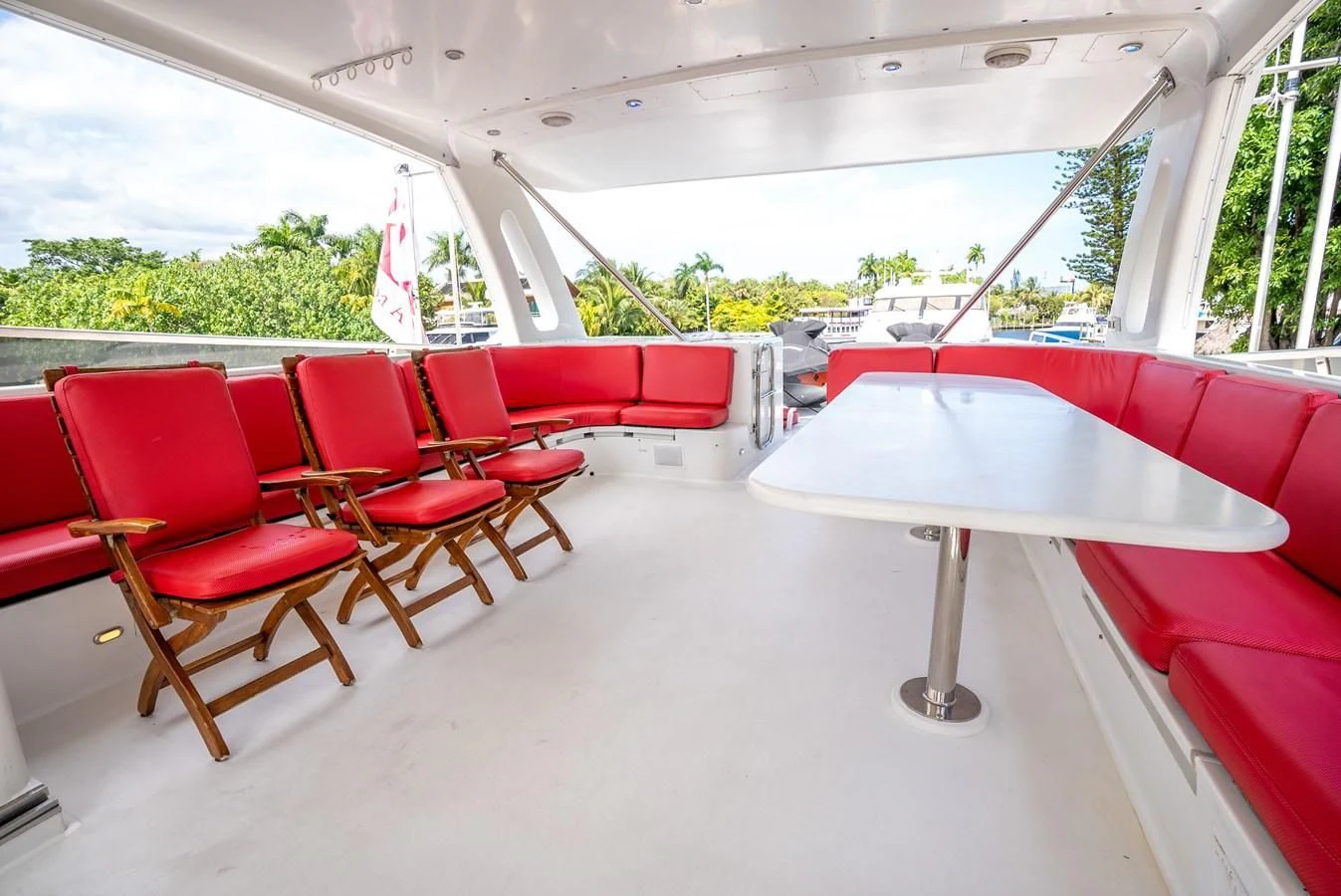 a group of red chairs in a room with a table and a white table aboard SELF MADE Yacht for Sale