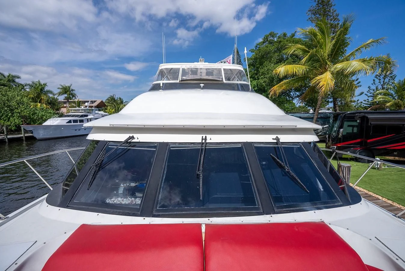 a white boat on a dock aboard SELF MADE Yacht for Sale