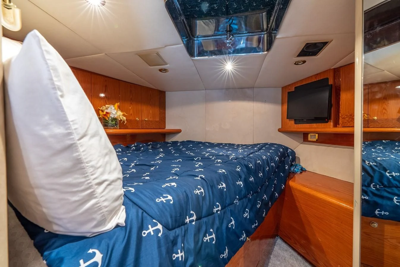 a bedroom with a blue blanket aboard SELF MADE Yacht for Sale