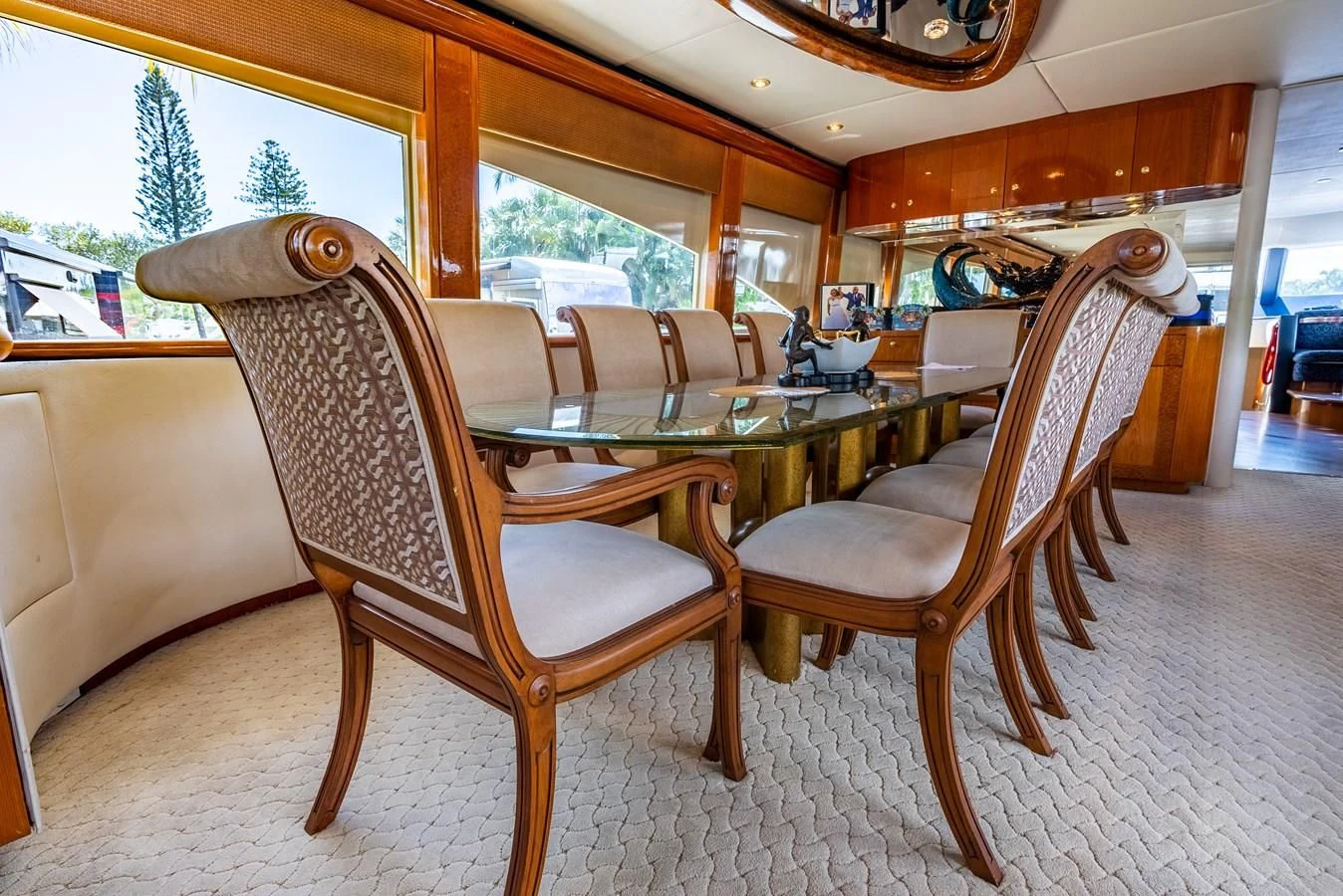 a wooden dining table and chairs aboard SELF MADE Yacht for Sale
