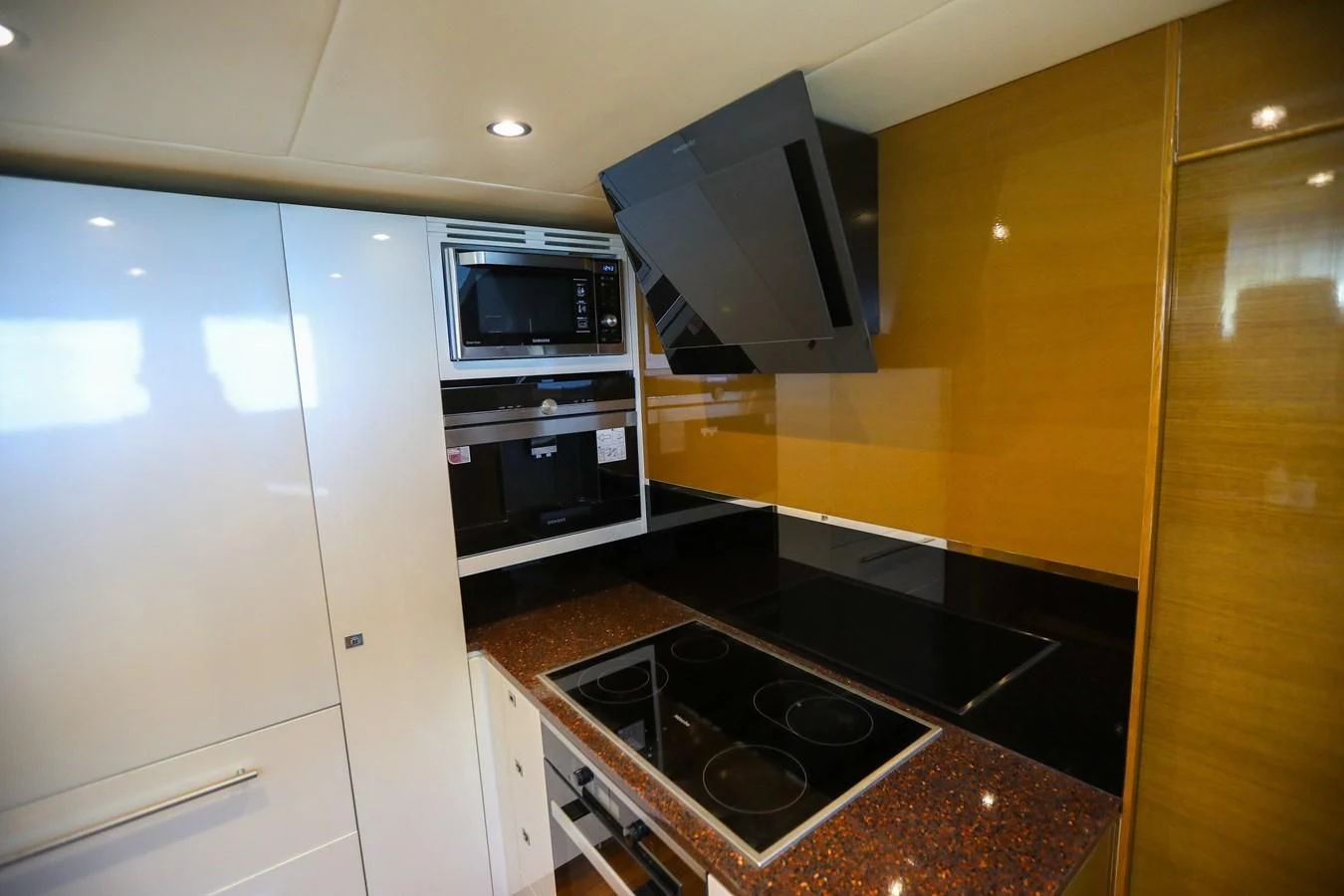 a kitchen with a stove and microwave aboard M Yacht for Sale