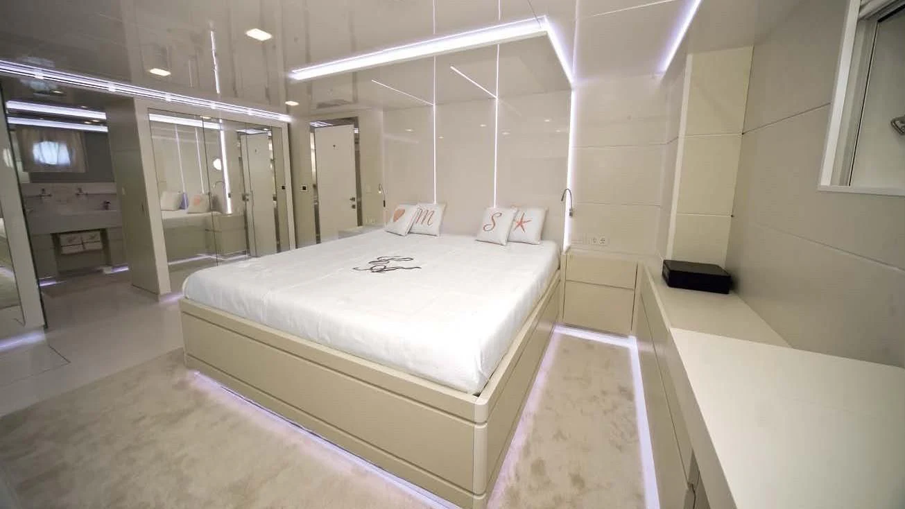 a room with a bed and a desk aboard OCEAN KING 88 Yacht for Sale