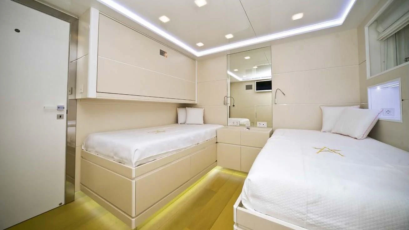 a room with two beds aboard OCEAN KING 88 Yacht for Sale