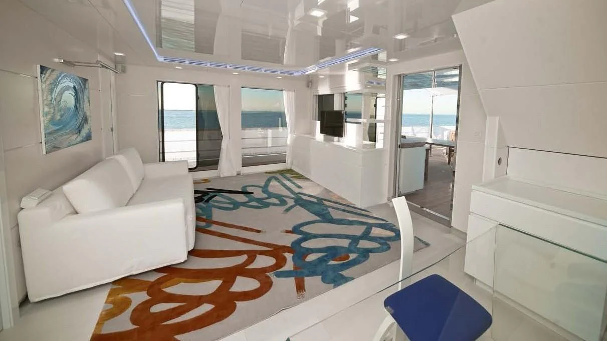 a room with a couch and a rug aboard OCEAN KING 88 Yacht for Sale