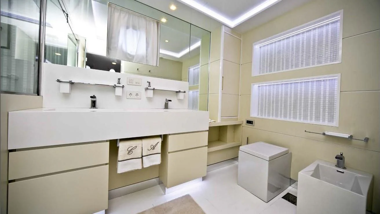 a bathroom with a large mirror aboard OCEAN KING 88 Yacht for Sale
