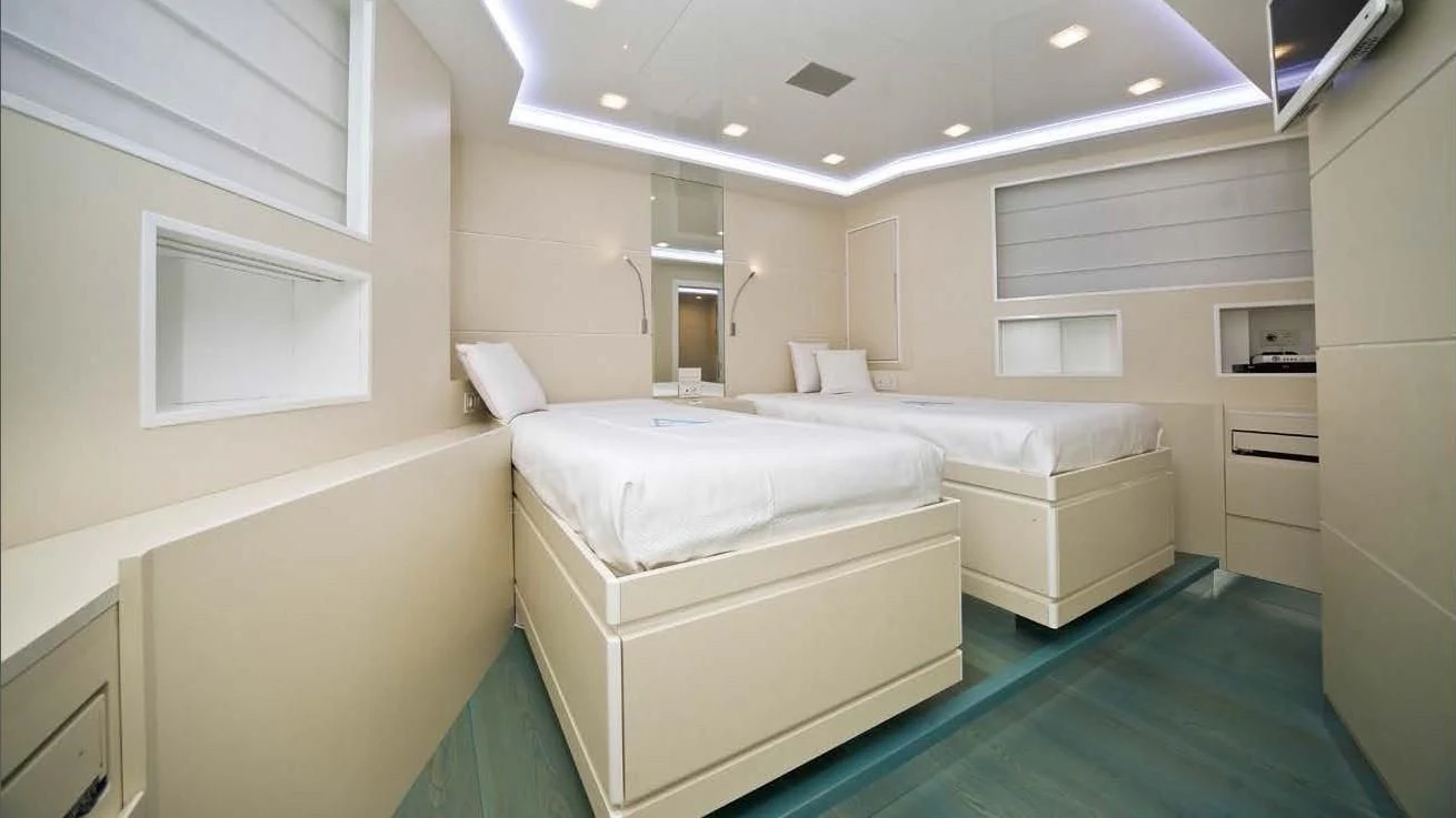 a room with several beds aboard OCEAN KING 88 Yacht for Sale