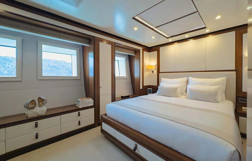 a room with a bed and a desk aboard NEW WAVES Yacht for Sale