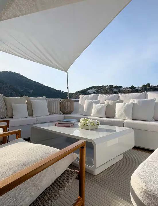 a white couch and a white table in a room with a white couch and a white table and aboard NEW WAVES Yacht for Sale