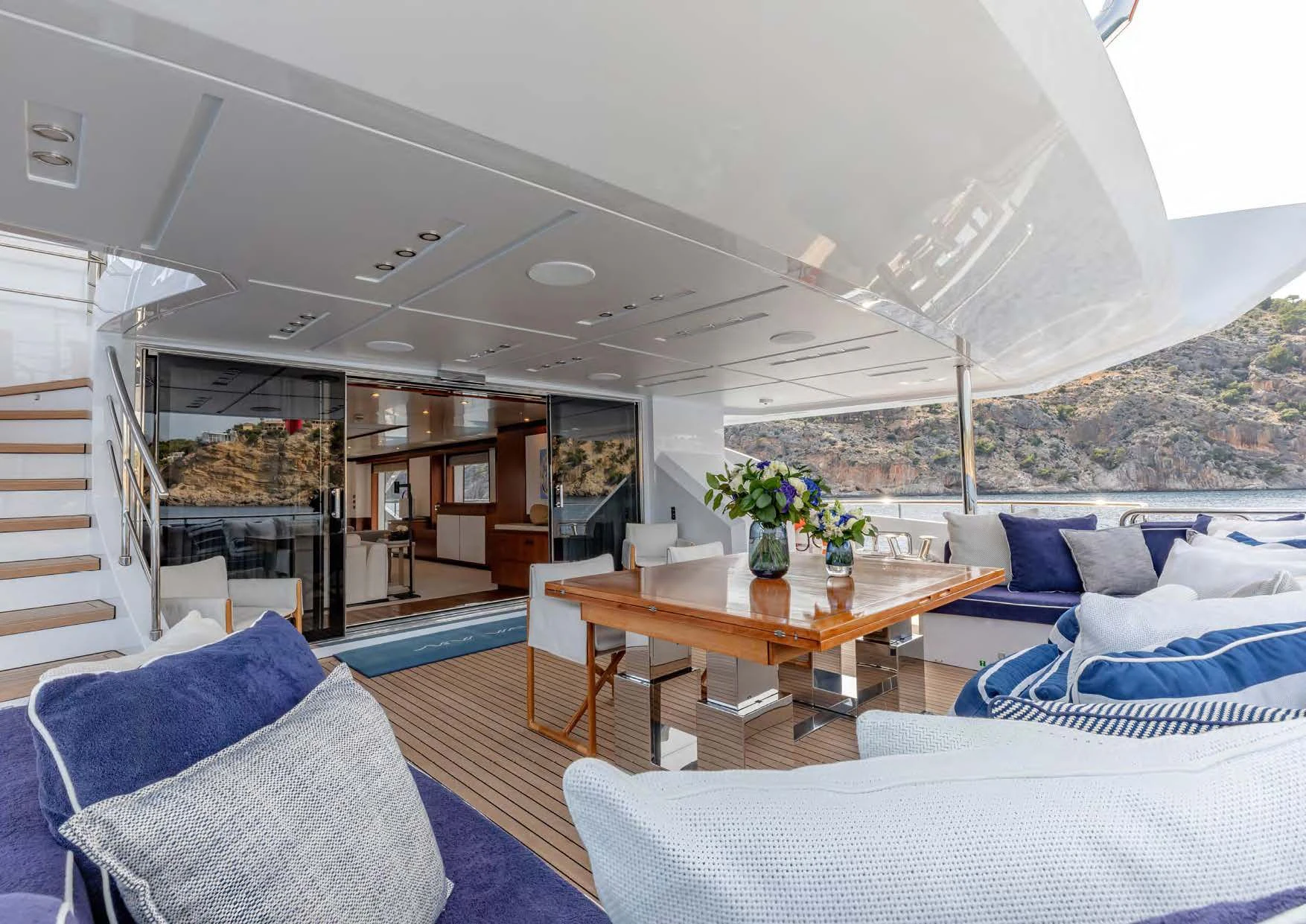 a room with a table and couches aboard NEW WAVES Yacht for Sale