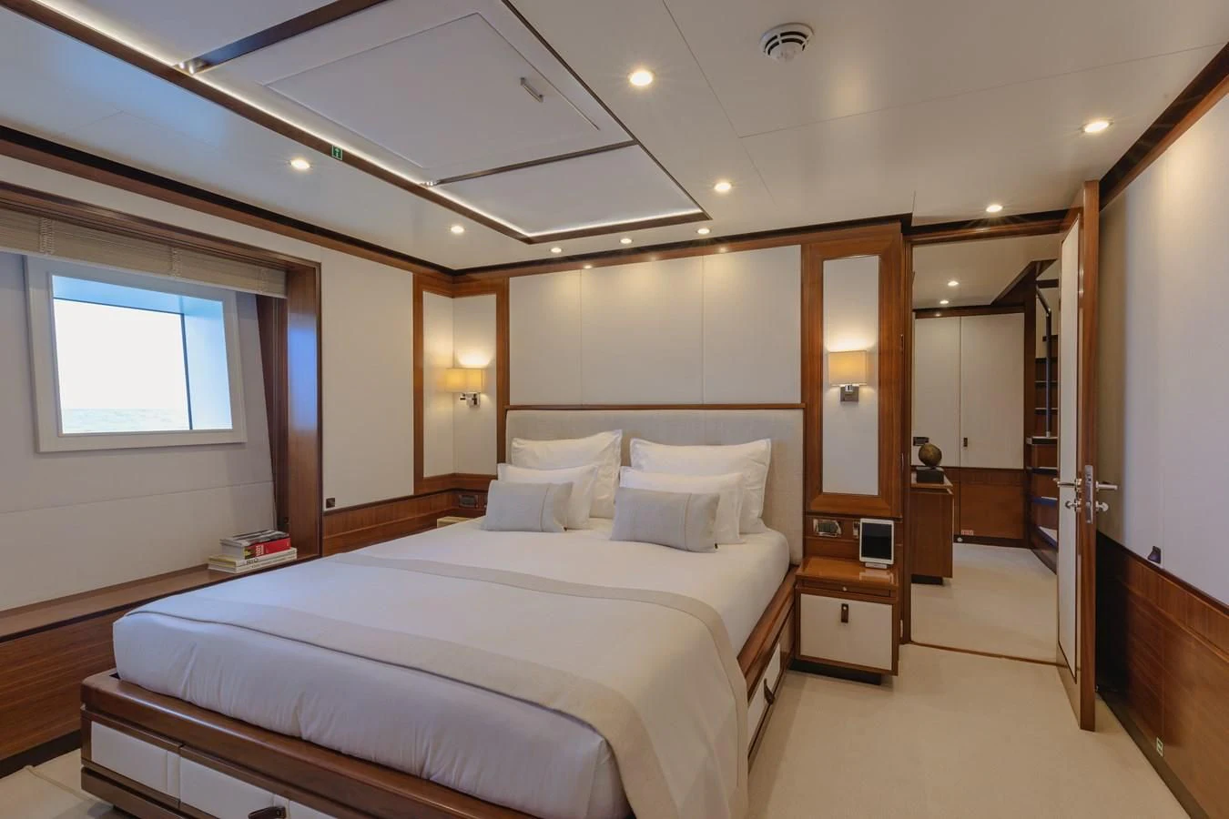 a room with a bed and a mirror aboard NEW WAVES Yacht for Sale